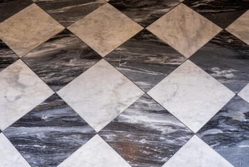 black and white tiles, old stone floor, background, texture, close up.