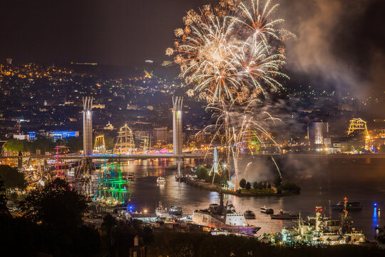 ROUEN, NORMANDY, FRANCE: city lights, Armada 2019 tall ships at night, Flaubert Bridge illuminated and fireworks over the Seine valley