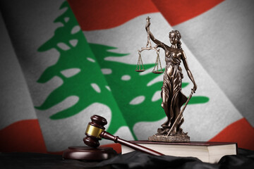 Obraz premium Lebanon flag with statue of lady justice, constitution and judge hammer on black drapery. Concept of judgement and guilt
