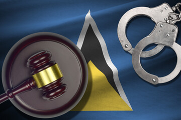 Saint Lucia flag with judge mallet and handcuffs in dark room. Concept of criminal and punishment,...