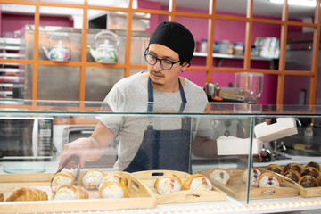 Baker selects the croissant to dispatch the order