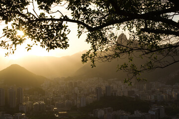 Sunset with Christ the Redeemer in Rio de Janeiro and its mountains