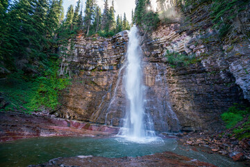 Virginia Falls and natural pool. Idyllic place after the trail. Glacier National Park. Montana, USA.