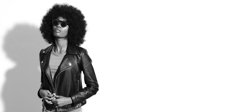 Black and white pictures of fashion model with afro hairstyle.