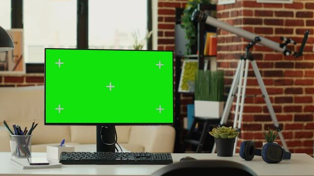 Empty office with monitor and greenscreen on computer, showing chroma key display and isolated mockup template. Desktop pc screen with blank copy space background in living room.