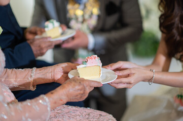 The bride and groom give the cake