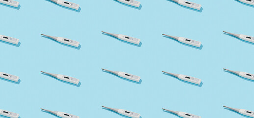 Pattern with digital thermometer on a blue background with deep shadows. Healthcare pharmacy and medicine concept