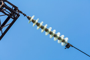 A sunny day, a power transmission line against a blue sky.