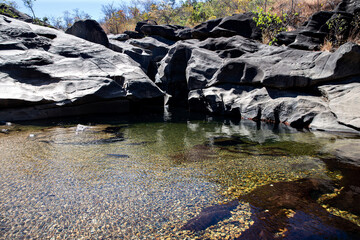Rocks, stones and the river with the sky like a background