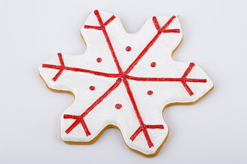 Red and white snowflake Christmas tree ornament on a white background