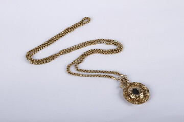 Ornate vintage gold necklace against a white background