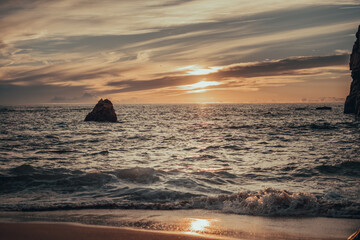the reflection of the setting sun on the waves of the ocean. beach and rest. concept of romance