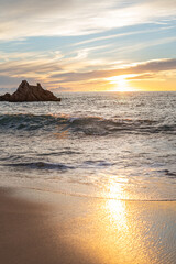 sea waves in the rays of the setting sun. concept of romance and rest on the beach