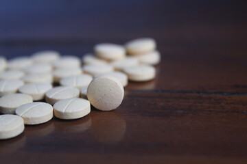 yellow medicinal tablets scattered on the table