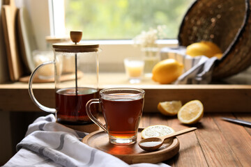 Delicious tea, sugar and lemon on wooden table, space for text