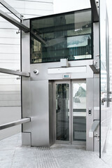 Modern large and silver inclusive elevator on street