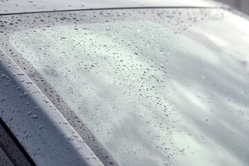 Rain drops on car windshield, closeup view