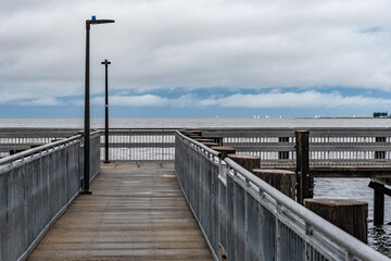The wooden pier at Bonnabel Park in New Orleans offers a stormy view over the water.