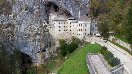 Fototapeta na wymiar Predjama castle is a unique cave what built in a cave entrance. Renessiance style fortress from 12th century in Slovenia Julian apls Mountains. One of the biggest cave castles of the world