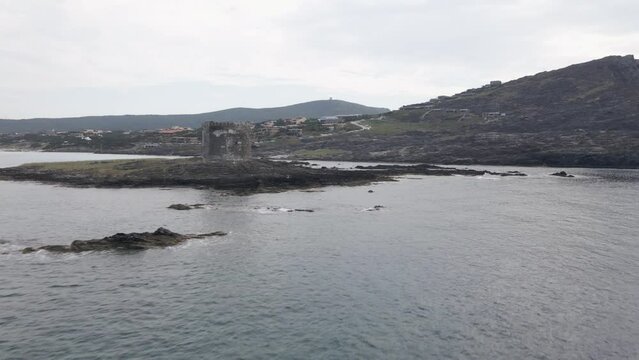 Aerial shot of the beach Spiaggia della Pelosetta and the island Sardegna on a gloomy day, Italy