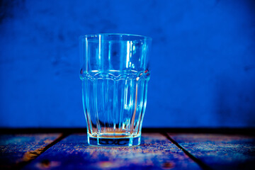 glass of water blue background 