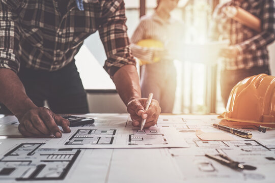 Professional architect designer structural engineer team colleagues discussing building plan design project