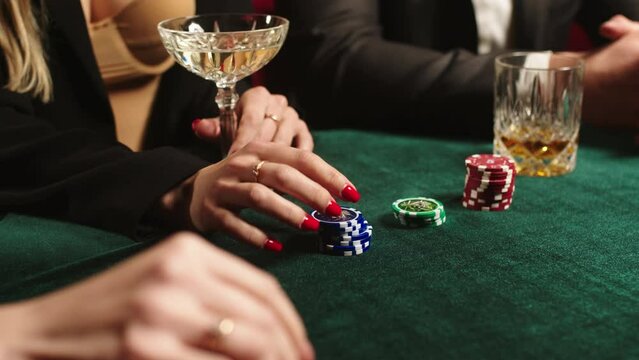 Close up of stacks of generic poker chips on a black felt table. Concept of casino gambling or poker and entertainment.