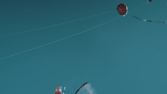 Colorful Giant Kites Flying Against Blue Sky In Sumpango, Guatemala - low angle