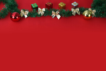 Merry Christmas image with red background and christmas ornaments on top.