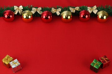 Merry Christmas image with red background and christmas ornaments on top.
