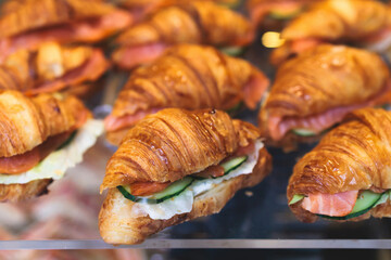 Catering table, beautifully decorated banquet table with variety of different food snacks, sandwiches, croissants and appetizers on party event or celebration, delicatessen setting, coffee break