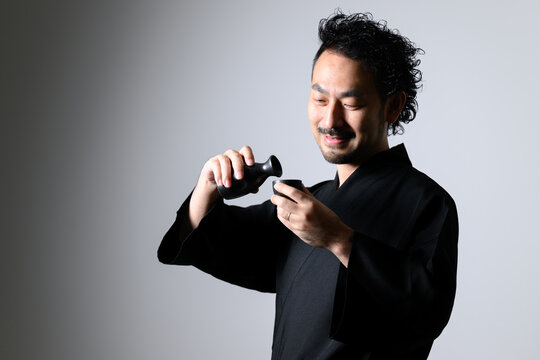 Image of a middle-aged man pouring sake