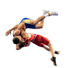 Two  strong men in blue and red wrestling tights are wrestlng and making a suplex wrestling on a...