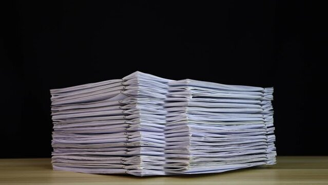 stack of paper documents with clip on a wooden table. Corporate business financial data management concept. Organize Documents &ndash; 4K Stop Motion, Stack Files Overload	
