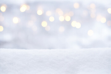 Blurred Christmas lights and snow. Winter background, glitter defocused lights, bokeh, Snowflakes and snowfall