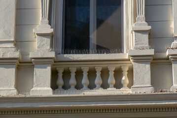 Bird control spikes, anti-roosting spikes, pigeon spikes or roost modification on the facade of a building.