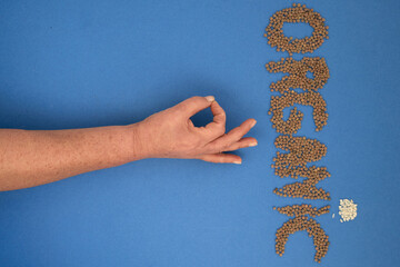 formation of the word organic with legumes and cereals together with an arm and fingers forming ok