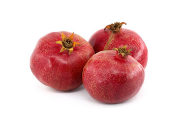 Three whole pomegranate fruits isolated on white