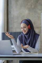 
Muslim female student in hijab studying online with laptop Asian girl in headphones doing homework with digital tablet teaching online Muslim female teacher is making a video call.