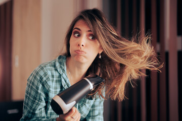 Woman Drying her Hair Using Heat Worried about Healthy Hair. Stressed girl worrying about hair...