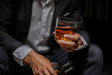 Closeup businessmen holding a glass of whiskey