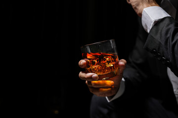 Closeup businessmen holding a glass of whiskey
