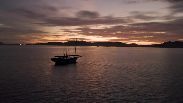 Silhouette of fishing boat, drone flyby. Langkawi, Malaysia. 