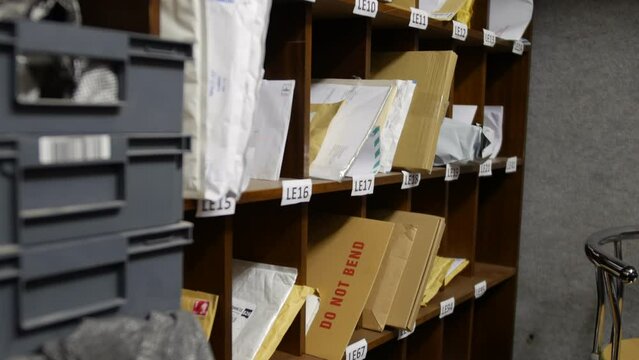 A post office mail room and sorting office with letters and shelving