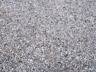 Gray small pebbles background for driveway or garden path decoration. Dark pebble and gray dry pebble. Smooth round pebbles texture background. 
