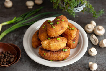 Fried patties with potatoes, mushrooms and green onions, homemade food