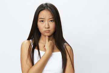 Asian woman hand signals, finger pointing facial skin problems, acne and inflammation, red rash and...