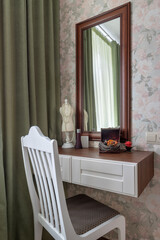 Makeup room interior with wooden table and large mirror