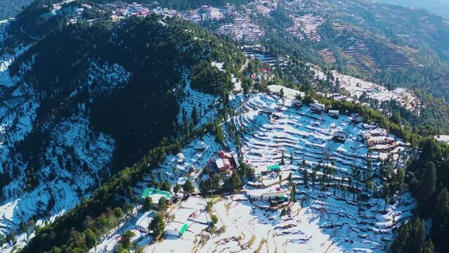 Mussoorie,Uttarakhand India- January 15 2022- Aerial winter landscape of trees and fields covered in snowfall . Snowfall in Mussoorie, Uttarakhand India. Aerial view of beautiful snow-covered