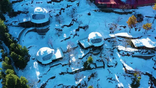 Mussoorie,Uttarakhand India- January 15 2022- Aerial winter landscape of trees and fields covered in snowfall . Snowfall in Mussoorie, Uttarakhand India. Aerial view of beautiful snow-covered